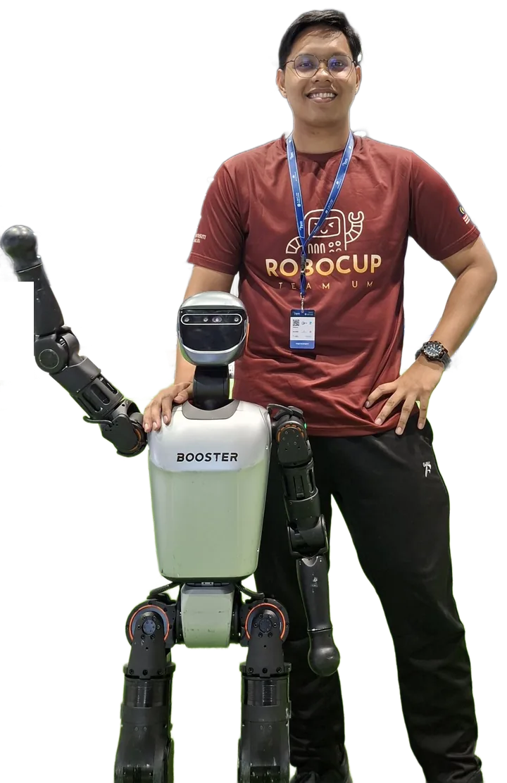 Tareq standing beside the Booster T1 humanoid robot